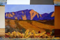 Rough painting of a mountain range at sunset.