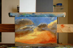 A rough painting of storm clouds at sunset.